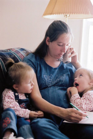 over stressed mother speaks on phone after completing information for child adoption